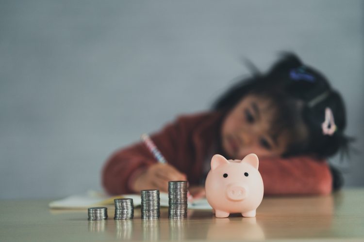 Family Saving money. Asian baby girl daughter plan to spend the future in earnest, finance and saving, family and financial concept.
